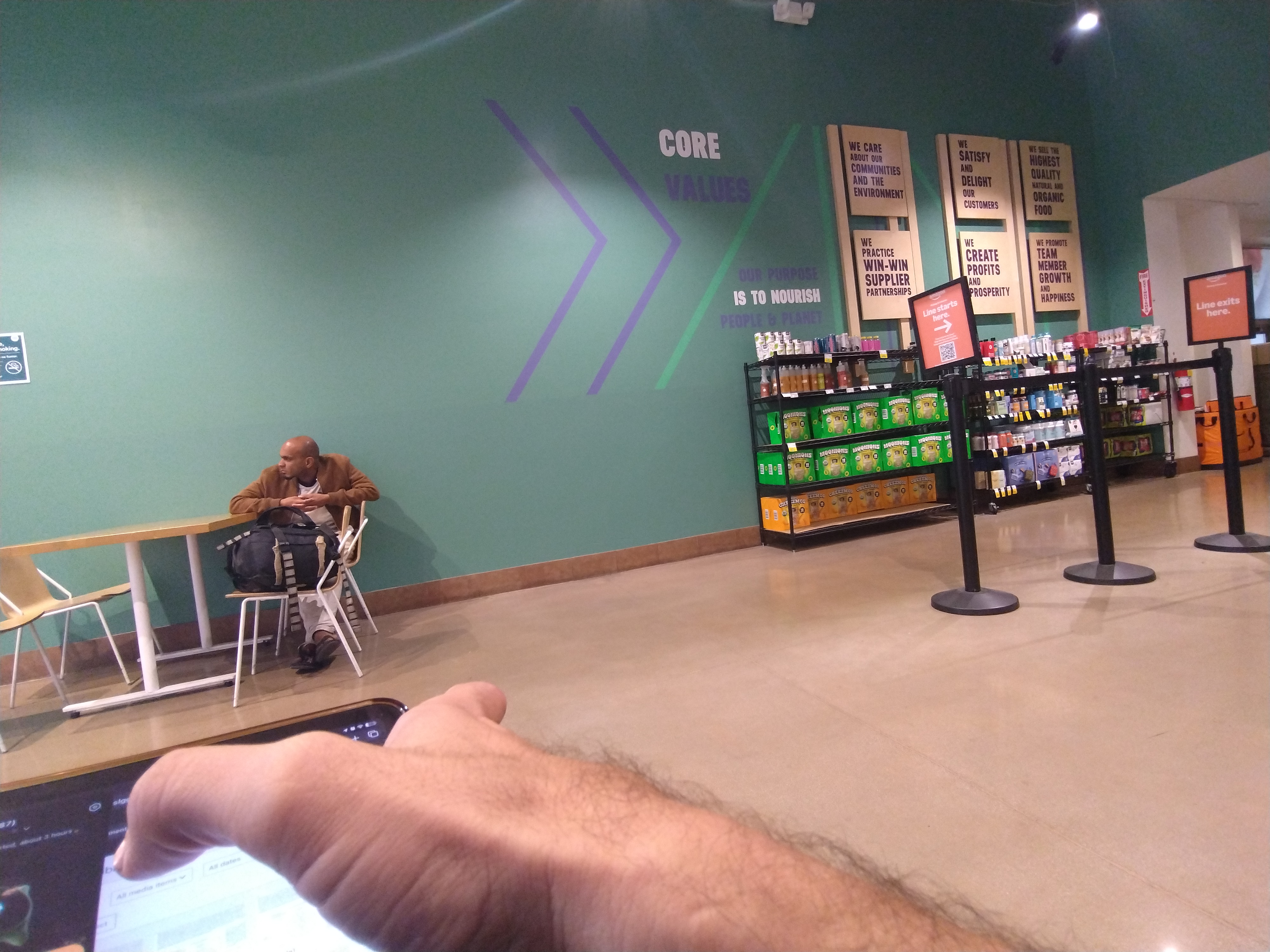 Browsing on a phone in a grocery store cafe