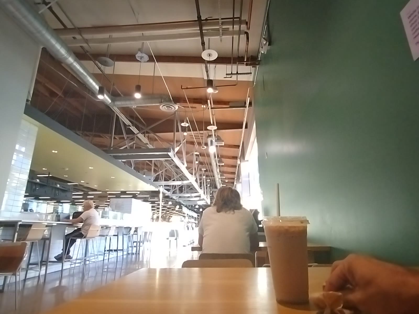 Coffee and Video Scrolling at a Cafe